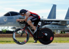 Craig Mitchell, 24, of Abington zooms past the 102nd Intelligence Wing retired F-15 Eagle jet outside the gates of Otis Air National Guard base during the Hero Triathlon on Sunday, June 22, 2014.