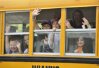 West Villages Elementary School students wave to their teachers as their bus pulls away on the last day of school. 