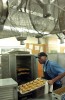 Maurice Cole pulls out a tray of calzones from the warmer just before the dinner rush at the Sharpe Refectory dining hall on the Brown University campus on Thursday, April 19, 2007.