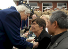 Hilda Levesque of Seekonk presents the Gold Star Mother pin to Anne-Marie Valdepenas, whose son was killed by a roadside bomb in Fallujah in 2006, during a post office dedication ceremony in his honor on Sunday, June 28, 2009. Ms. Levesque's son is currently on his second tour of Iraq and when she pinned Mrs. Valdepenas she said to her: {quote}From one Iraq War veteran's mother to another.{quote}