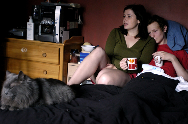 Matthew and his girlfriend, Hannah DeRemer, 20, have coffee in bed with his cat, Flannel, in their Boston apartment. Matthew is recovering from an orchiectomy from the day before. Doctors discovered that his remaining testicle was leukemic and needed to be removed a few days earlier. He lost his other testicle the year before during his first relapse. 