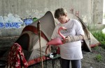 Barbara Kalil, 50, settles into her new space underneath the Washington Bridge in East Providence. {quote}I try to make things homey. Home is where ever you are.{quote} Kalil said while placing pink flamingo yard decorations outside the entrance to her tent.