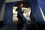 Ralph Esposito III, who shares a tent with his father, cleans out the bedding in an effort to prevent rodent and pest infestation. He and his father were particularly upset about Freitas's latest arrest and said that the camp has lost donors over the controversy. {quote}We don't condone sex offenders.{quote} Esposito said.