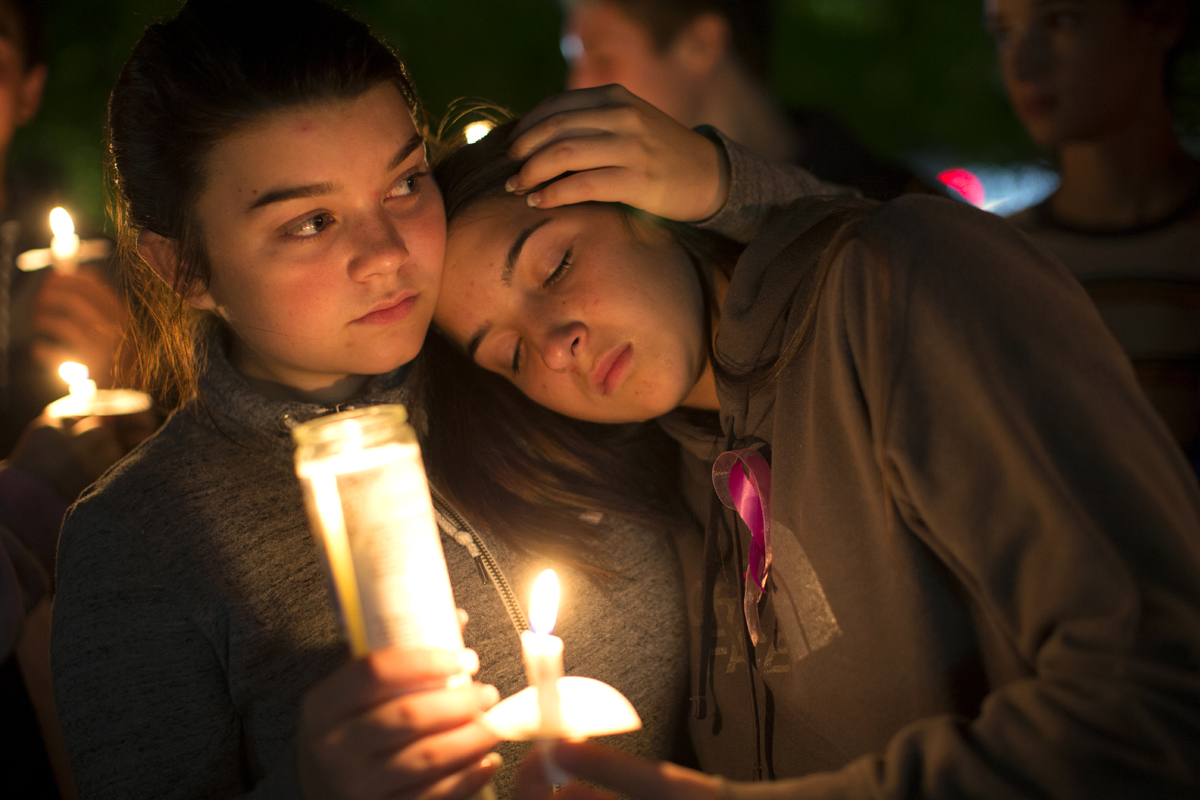 BURLINGTON, WA - SEPTEMBER 26: Tatum Sprouse (left), 17, and Rainah Douglas, 16, both from Mount Vernon, Washington, participate in a candlelight vigil along Burlington Boulevard on September 26, 2016 in Burlington, Washington. Five people were killed by a gunman several nights ago at thre Cascade Mall. One of those killed was a classmate of theirs at school. The suspect, Arcan Cetin, 20, a resident of Oak Harbor, Washington, was arraigned today. (Photo by Karen Ducey/Getty Images)