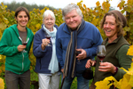 Founders Jo Ann and Gerard Bentryn (center left and right), of Bainbridge Island Vineyards and Winery with Robin Bedony (left) and Betsey Whittick (right). Several farms work on the 40 acre piece of land growing a diversity of crops including lettuce, garlic, beans, squash and potatoes. {quote}We all work cooperatively to create a local food community and culture.{quote} says Whittick.  {quote}Access to land is a challenge for young farmers.{quote} she said and Robin is part of the new generation of farmers, now a working member of Bainbridge Vineyards LLC.  Whittick is in the process of taking over the winery and vineyards operations. (Photo by Karen Ducey/Puget Sound Business Journal)