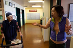 Teresa Moy (R) drops off face cream and pears for her mother i in-law, Suit Moy, at the International Community Health Services’ assisted living facility, the Legacy House, on March 20, 2020 in Seattle, Washington. Her mother doesn’t understand why her daughter- in- law can’t stay and visit. The Legacy had closed to visitors, including family members, to help curb the spread of the coronavirus. The International Community Health Services is a non-profit clinic that cares for uninsured patients, low income people and immigrants who rely on federal aid programs. Non-profit community health centers around the country are facing the expiration of federal funding they rely on in May as coronavirus (COVID-19) continues to spread. (Photo by Karen Ducey/Getty Images)