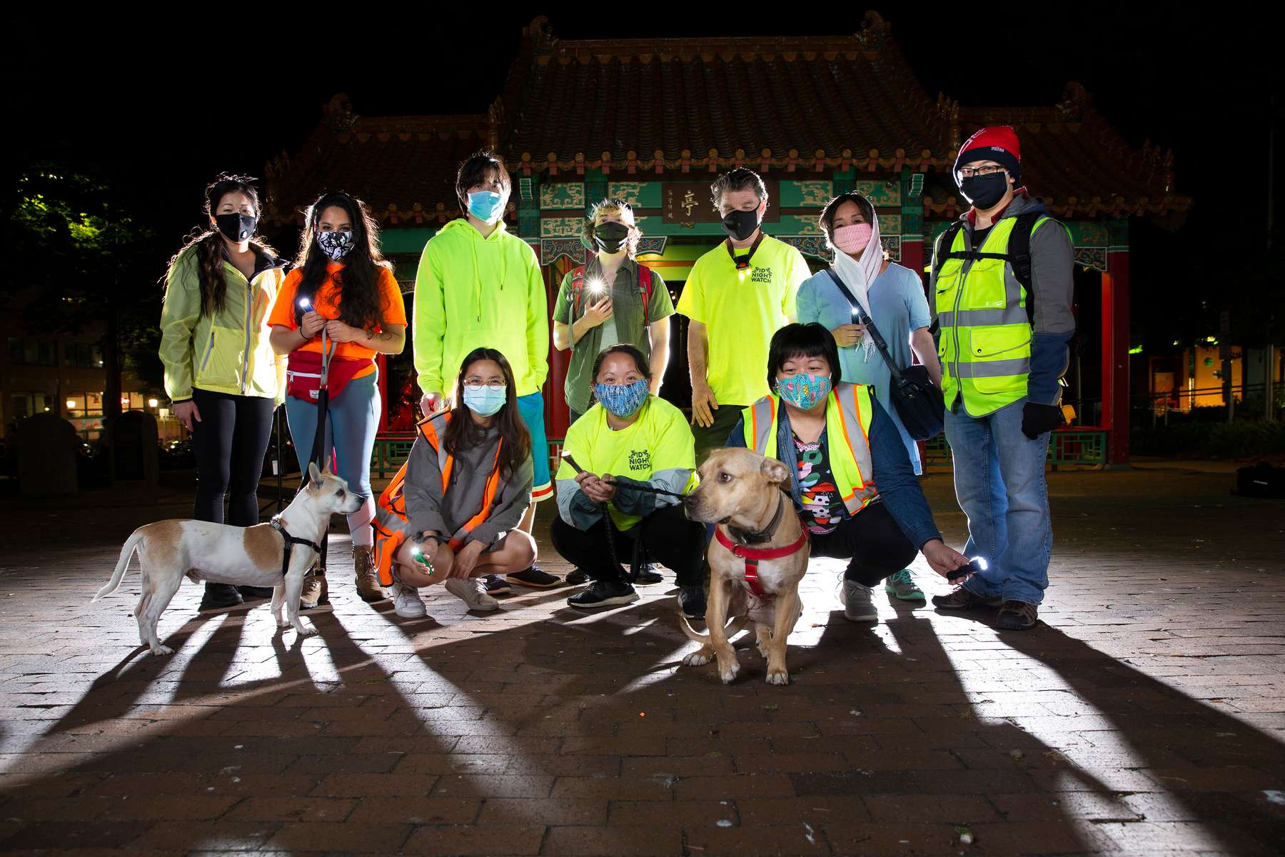 Volunteers of the Night Watch group pose for a photo before the start of their shift patrolling in the Chinatown - International District in Seattle, Washington on July 20, 2020. After a wave of looting, vandalism and racist incidents in the neighborhood in early June the group took matters into their own hands. They patrol the neighborhood from 10pm until 2pm every night.
