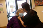 Sherri Chu, the front desk coordinator at the Legacy House, and assisted living facility associated with the International Community Health Center, fixes a mask on resident Chen Zhixian. “We try our best to make sure the residents wear a mask,” she says in Seattle, Wash. on May 29, 2020. 