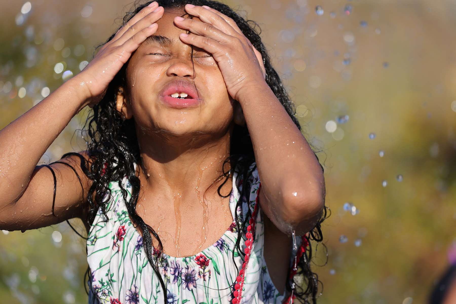 Isis Macadaeg, age 7, plays in a spray park at Jefferson Park during a heat wave in Seattle, Washington, U.S., June 27, 2021. REUTERS/Karen Ducey