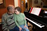 Mark Backlund, 73, gives his wife, Ruth Backlund, 72, a kiss as the two recover from the coronavirus (COVID-19) at their home in Anacortes, Washington on March 27, 2020. Both of them are singers in the Skagit Valley Chorale that experienced a huge uptick in members getting the coronavirus after a rehearsal at a church in Mount Vernon, Washinton on March 10. 27 tested positive for COVID-19. Two have died. The outbreak in a rural community shows how contagious coronavirus is, and how quickly it can spread. (photo by Karen Ducey for the LA Times)