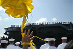 Carmen Sanchez holds balloons and waves to sailors aboard the USS Abe Lincoln as it returns home to Everett, Wash. in 2003 after 9 months at sea in the Persian Gulf.  Carmen was there greeting her son Jonathan from Oregon.