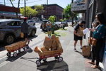 Volunteers and staff distribute food and groceries throughout the Chinatown-International District on May 7, 2020. Vincent Kwan, a program manager at InterIm says{quote}It's called disaster gentrification. An already vulnerable neighborhood having the impacts of COVID is already accelerating the gentrification that's already happening. So, we're very concerned about that.This community is meant for people that have been marginalized, have been pushed away from white neighborhoods historically. And they found refuge here. How do we protect a historical landmark and also a historical place for folks that call it home?{quote}(photo by Karen Ducey)