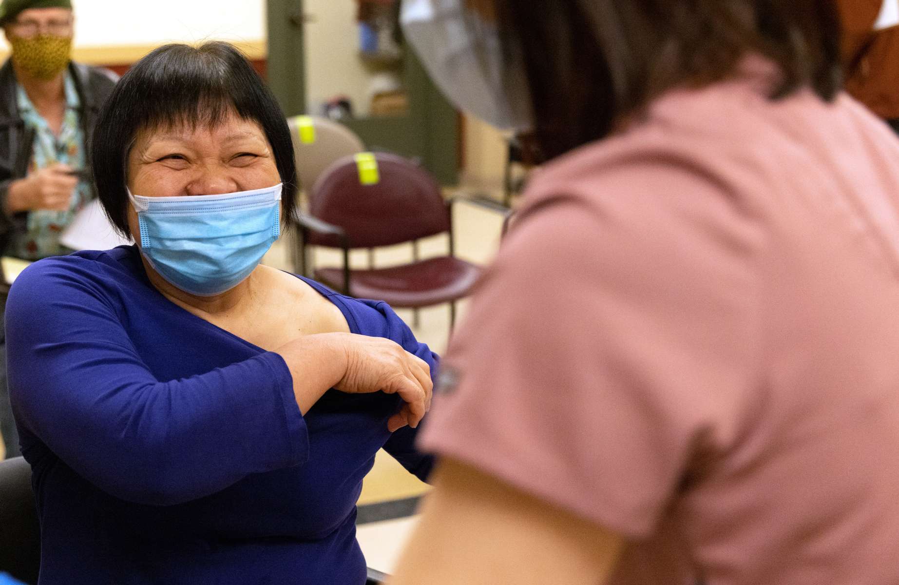 Kuang Suying, age 60, who works in a noodle factory in the Chinatown-International District, reacts after getting a Covid-19 vaccination shot at a pop-up clinic run by the International Community Health Services at the Bush Asia Center in Seattle, Wash. on March 18, 2021. (Photo but Karen Ducey)