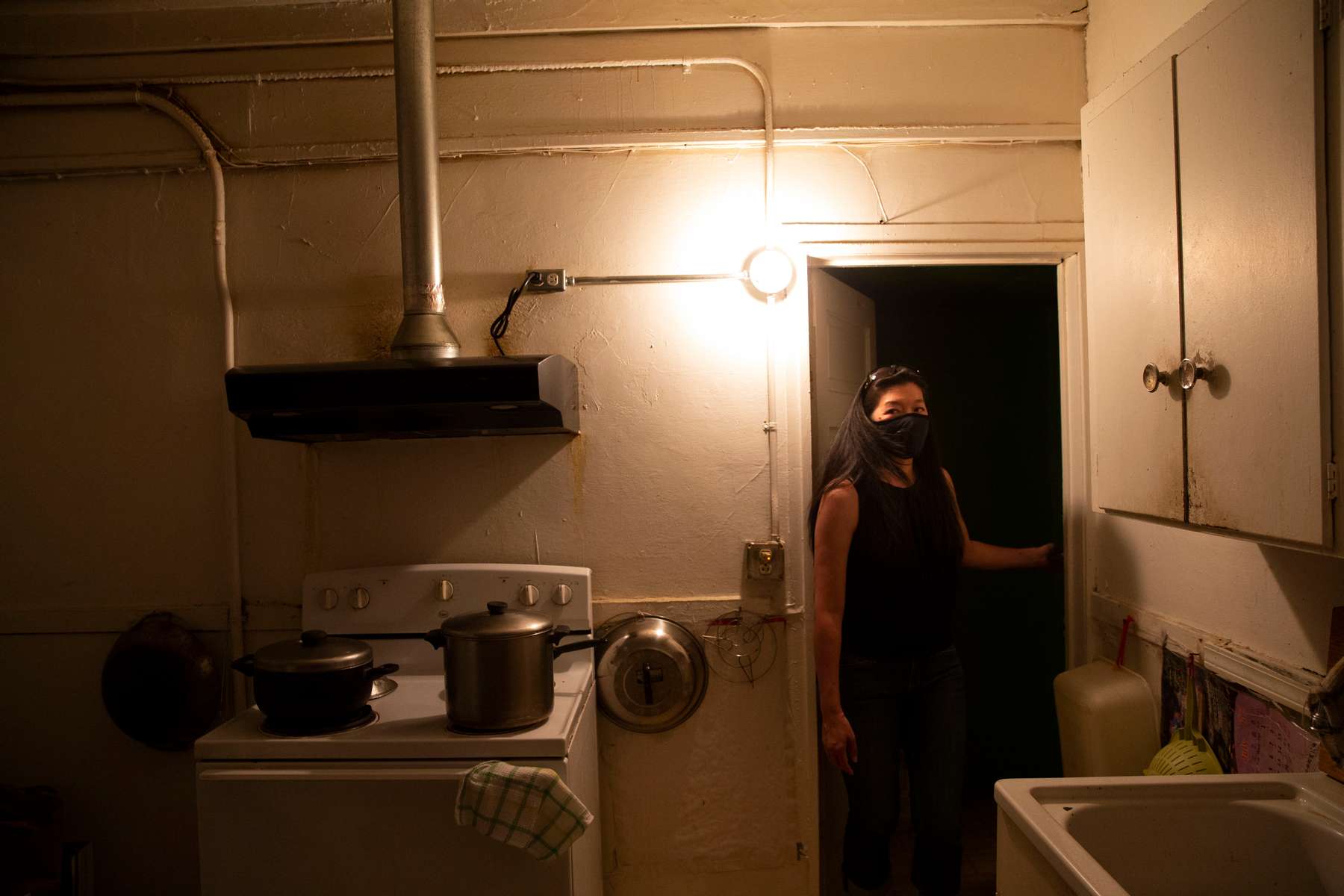 Angela Lee, stands in the kitchen of the home she grew up in in the Kong Yick Apartments  in the Chinatown - International District in Seattle, Washington on July 15, 2020. The apartment now belongs to her aunt. Donnie Chin, director of the International District Emergency Center (IDEC) was murdered on July 23, 2015. The murderer was never found. (Photo by Karen Ducey)