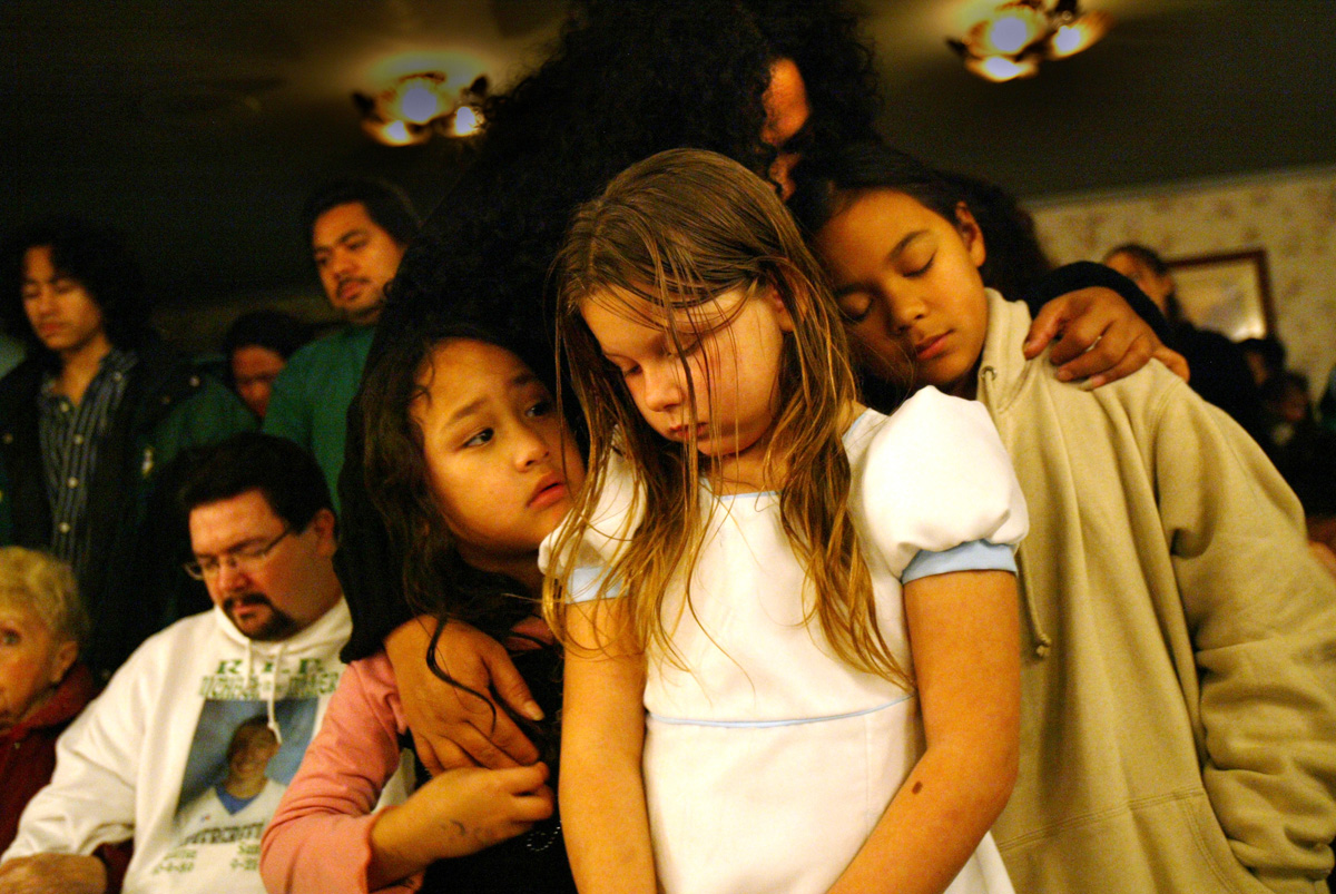  “I really miss him. “ says Mataio Jantoc, age 10 (right)  “Even though we’re little this has had one of the biggest impacts in our life and it just really hurts.” The Miller family participates in {quote}A Night of Remembrance{quote} at the Greenwood Memorial Park and Funeral Home on December 10, 2006 in Renton, WA. The Miller family opened their door to me during a very difficult time in their lives.  I spent a year documenting their distress after one son accidentally shot and killed his brother while the two were playing with a handgun in the family's home.  I will always be grateful to them for sharing their story with our readers and bringing the children with guns issue to light. (PI photo/Karen Ducey)