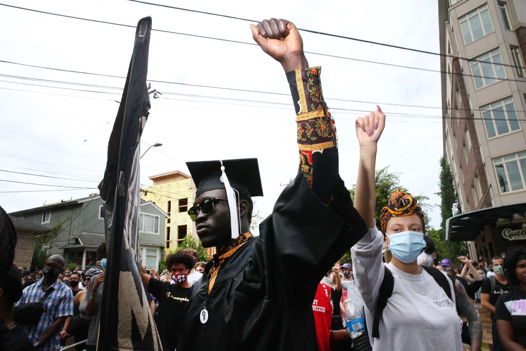 SEATTLE, WA - JUNE 19: Latio Cosmos (L), who recently graduated from Seattle University with a degree in public affairs, participates in the Juneteenth Freedom March and Celebration  on June 19, 2020 in Seattle, Washington. Juneteenth commemorates June 19, 1865, when a Union general read orders in Galveston, Texas stating all enslaved people in Texas were free according to federal law. (Photo by Karen Ducey/Getty Images)