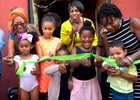 From left to right back row adults: Klair Etheridge, Pamela Lewis-Bridges, Joye Hardiman, PhD, Patricia Corbert. Children left to right: DianaStarr Robinson, 6, Ashea Nougera, 9, Olivia Frieson, 7, Kabby Mitchell Everly (fifth generation), 6, cut the ribbon marking the grand opening of the Tacoma Urban Performing Center (T.U.P.A.C.) on Saturday, July 8, 2017 in Tacoma, WA.. Kabby Mitchell, founder of T.U.P.A.C., lived in Tacoma, taught at The Evergreen State College and was the first African-American Principle Dancer for the Pacific Northwest Ballet. Kabby, unexpectedly passed away on May 4, 2017. Professional dance instruction will be offered there. (© Karen Ducey)