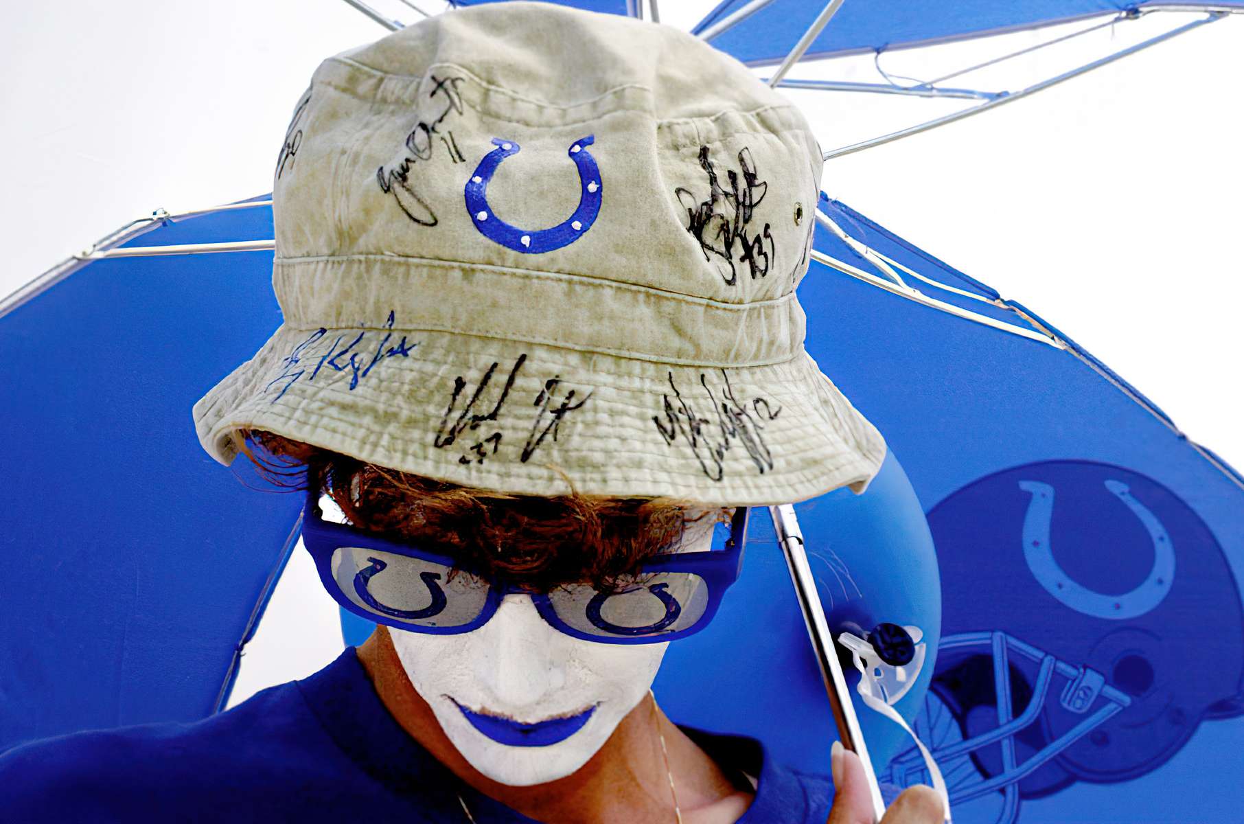 #50692. staff photo/Karen Ducey -- Dawn Timko from West Terre Haute dressed up for {quote}Do the Blue day{quote} at the Colts Training Camp.  Dawn has only missed 2 Colts practices since Training Camp began.  She is an avid fan and collects autographs from the players upon her hat after the practices end.  So far she has about 12 autographs on this hat, plus others on different items.  Dawn also won 4 tickets to the preseason game, August 24th, against the Vikings for her {quote}Do the Blue{quote} outfit. {quote}I do believe they're going to have a wonderful season.{quote} she said.