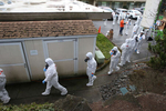 Clean up crews from Servpro gear up and go inside the Life Care Center of Kirkland, the long-term care facility linked to several confirmed coronavirus cases in the state, in Kirkland, Washington, U.S. March 11, 2020.  REUTERS/Karen Ducey