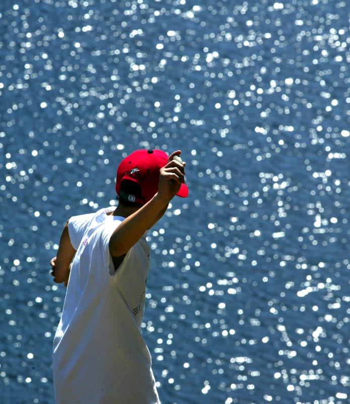 Nico de la Cruz, 11, from Port Orchard ,WA, throws rocks into Lena Lake while on a hike with his family.  Lena Lake, in the eastern Olympics, is a popular and moderately easy hike in the spring.