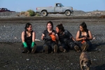 Sisters and set netters from left to right: Kayla Andrews, Selena Andrews, Karen Andrews, and Virginia Andrews, from Aleknagik, Alaska take a break on the beach in Ekuk, Alaska on the Nushagak River in Bristol Bay on July 5, 2019. Three generations of the family fish the setnet site, where the girls grandmother, Kay Andrews, says her grandmother, mother, aunts and uncles fished.