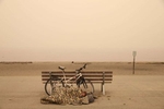 A man sleeps by a bench at Alki Beach in West Seattle as smoke from wildfires cover the city of Seattle, Washington, U.S., September 12, 2020.  REUTERS/Karen Ducey