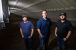 From left to right: Weber Family Farmsí managers and family members, Deven Johnson, Josh Lyebert, and Adam Weber stand on $1.1 million worth of ready-to-eat russet potatoes in one of their refrigerated potato storage bays in Quincy, Washington on May 1, 2020. That particular bay holds 16 million pounds of potatoes, 20 feet deep in a building 340 feet long -just slightly less than the length of a football field. Weber Family Farms is a a third-generation farming family, started by Adam's grandfather, Bill Weber, in the late 1960s.A billion pounds of excess potatoes in Washington state, second largest potato producer in the country. About 70 percent of its crop usually goes to overseas, to Pacific Rim countries primarily, in the form of french fries, but with so many restaurants/food service closed in U.S. and internationally, they have way more potatoes than they can sell. Last year they didnít have enough to meet demand; now growers are facing the prospect of losing it all. (photo by Karen Ducey)