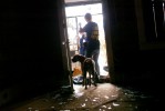 A volunteer from Pasado's safe haven leads a dog who had been locked and abandoned in his home two weeks after Hurricane Katrina struck. (© copyright Karen Ducey)