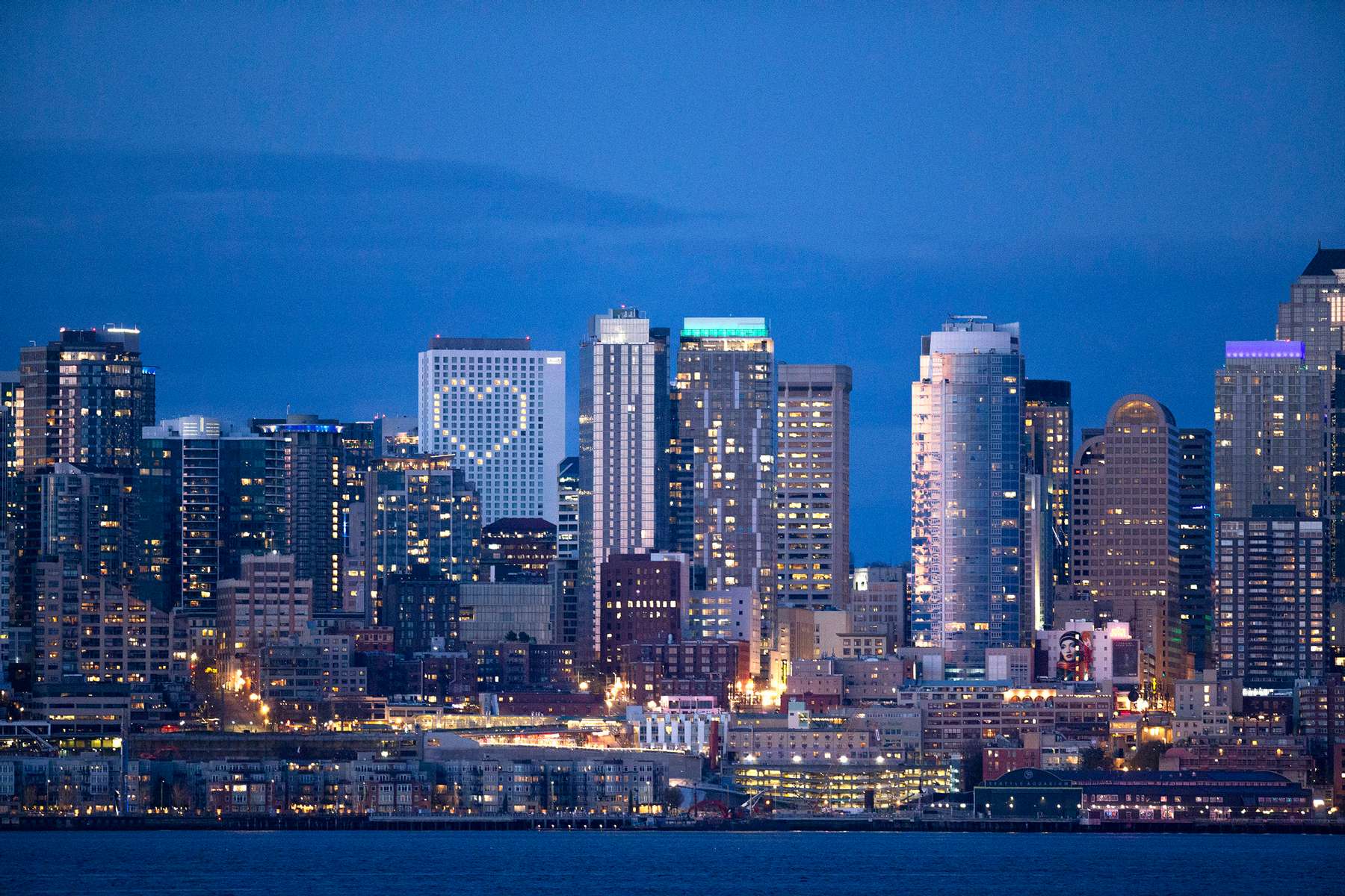The Seattle skyline is seen at sunset on April 6, 2020 in Seattle, Washington. Windows of the Hyatt Regency Hotel are lit up in the shape of a heart. Washington State Governor Jay Inslee extended the Stay at Home order until May 4th to help slow the spread of coronavirus (COVID-19). (Photo by Karen Ducey/Getty Images)