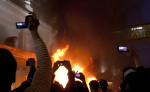 People record the chaos with cell phones, video and still cameras as rioters burn cars  in downtown Vancouver,BC after the Canucks were defeated by the Boston Bruins in the Stanly Cup on June 15, 2011. (photo copyright Karen Ducey)