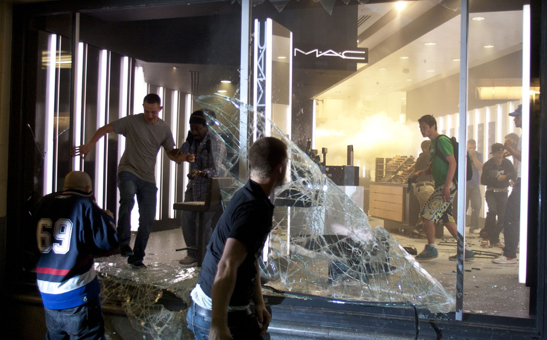 Rioters break windows and run through a store in downtown Vancouver,BC on June 15, 2011. (photo copyright Karen Ducey)