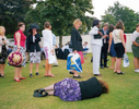 A woman lies on the grass next to the queue for the ladies’ toilet at the Henley Royal Regatta. July 2001