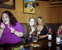 Young women put on lipgloss in a pub at the beginning of a night out in Newquay. July 2001
