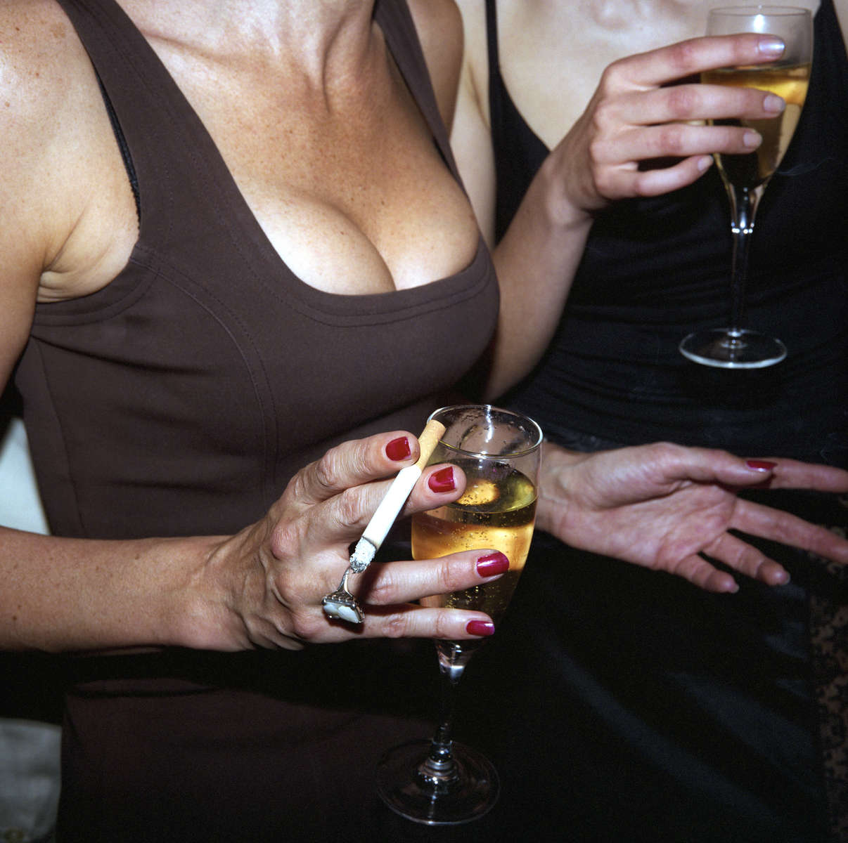 Two women drink champagne at a health resort launch party in central London. April 1998