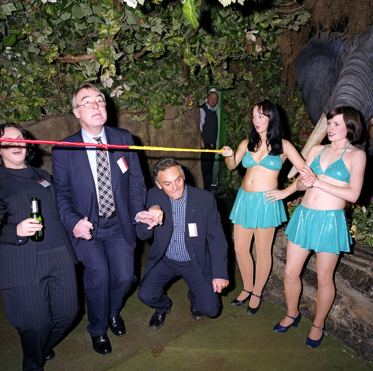 Staff and clients of Lawrence Graham, a firm of solicitors, join limbo dancers at the Rainforest Café, London. November 2002
