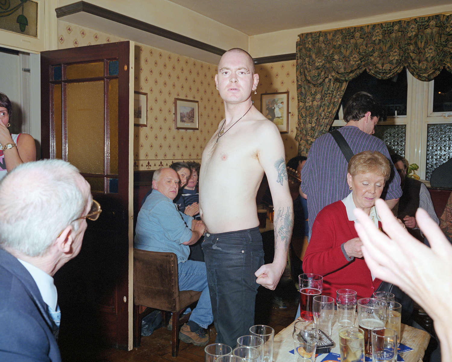 A bare-chested skinhead postures in a pub in the Lancashire town of Bacup. April 2001