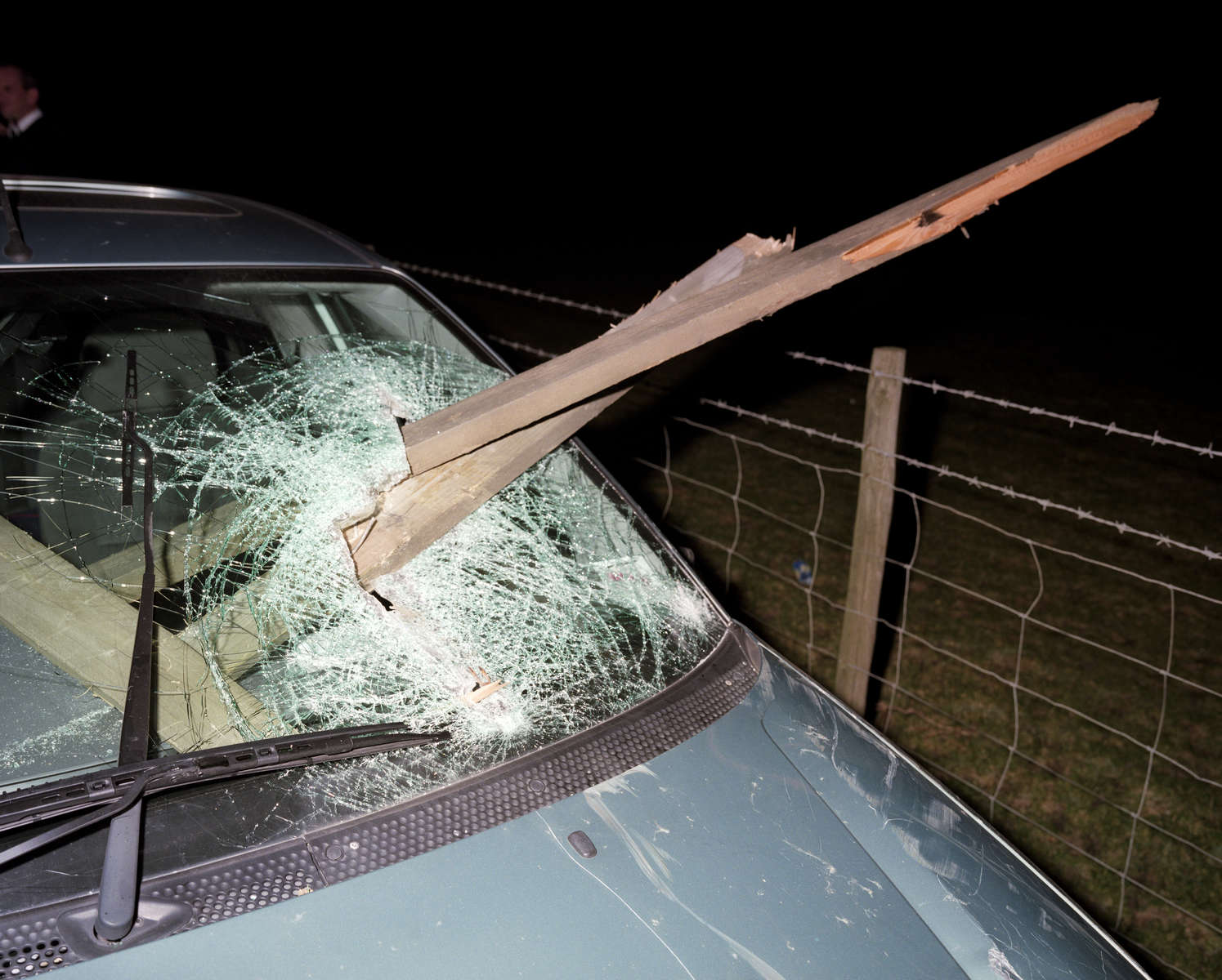 Near Bristol a car has crashed into a fence on a country road; the driver was suspected of being under the influence of alcohol. November 2001