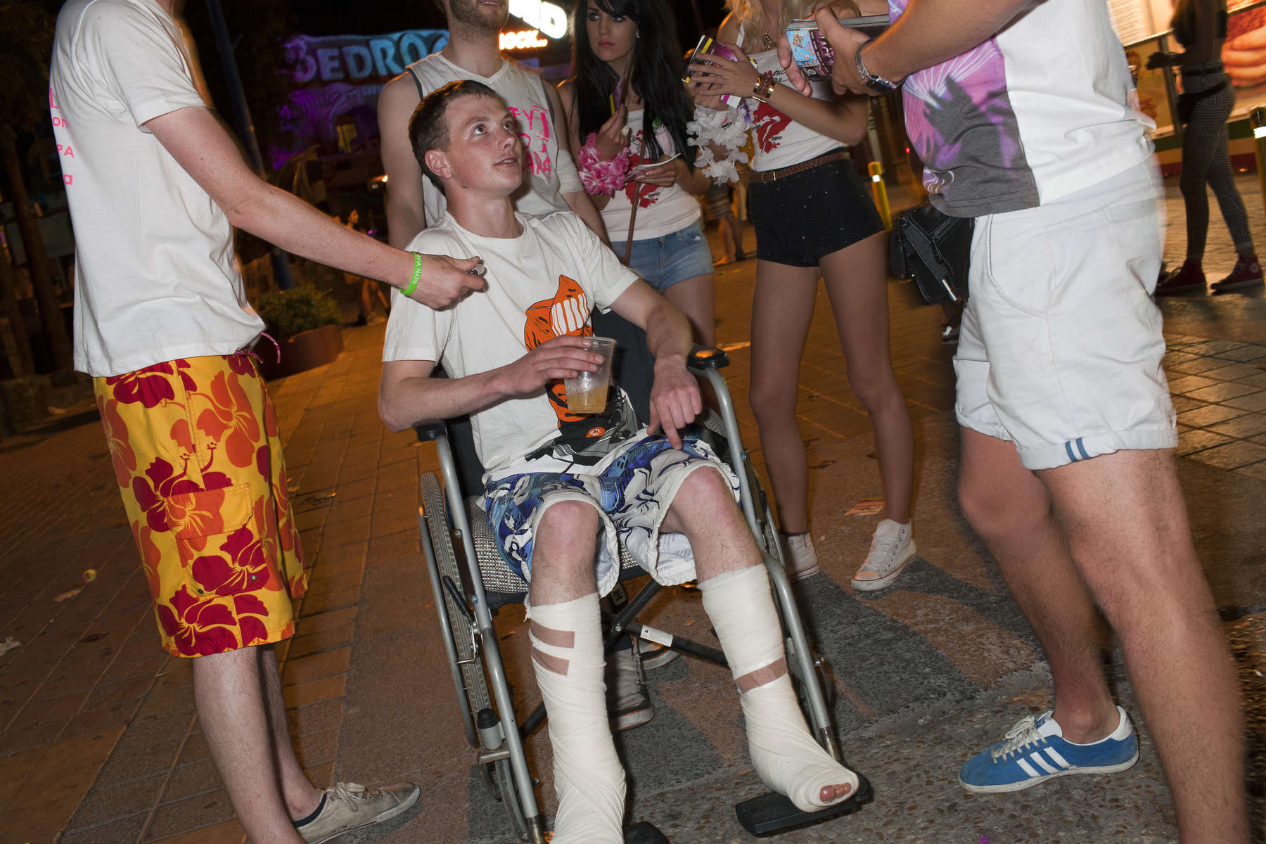 01:51 19 year old Calum, from Scotland, on the strip with friends in Ayia Napa, Cyprus. Calum slipped on the floor where he was staying and fell through a patio door and from a first floor balcony, severing the tendons in both of his legs. Travel operator, Thomas Cook, arranged three seats for him on the aeroplane home as Calum had appropriate travel insurance.