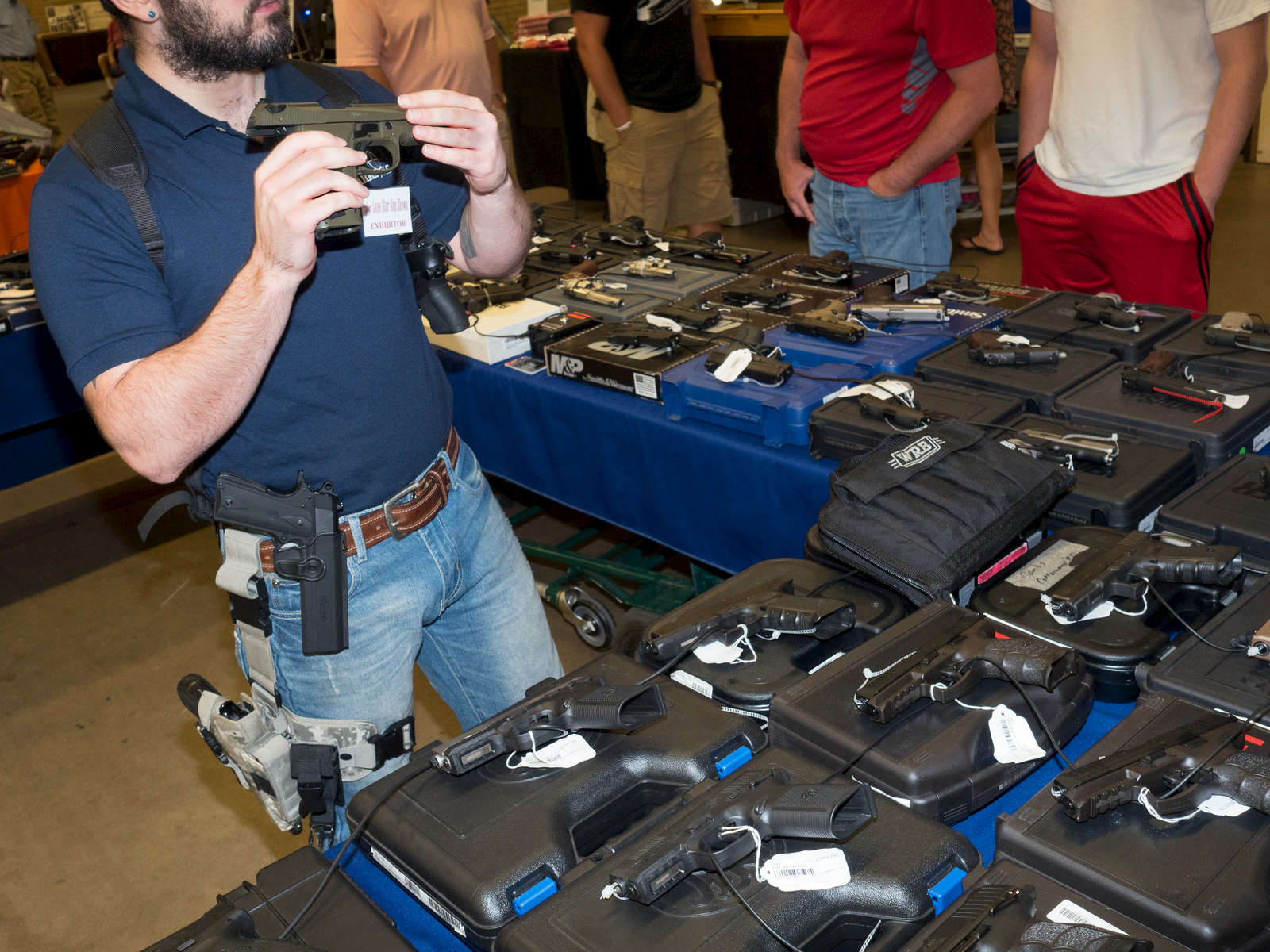 A stall employee checks a second hand gun at a show hosted at the Will rogers Memorial Center in Fort Worth.Dallas is a major city in Texas and is the largest urban center of the fourth most populous metropolitan area in the United States. The city ranks ninth in the U.S. and third in Texas after Houston and San Antonio. The city's prominence arose from its historical importance as a center for the oil and cotton industries, and its position along numerous railroad lines.For two weeks in the summer of 2015, photographer Peter Dench visited Dallas to document the metroplex in his epic reportage, DENCH DOES DALLAS.Photographed using an Olympus E-M5 Mark II©Peter Dench/Getty Images Reportage