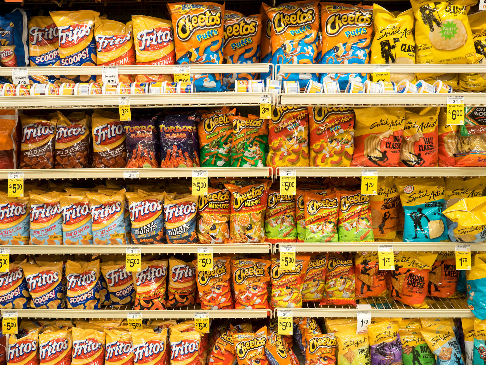 Crisps for sale in a supermarket in the Richardson district of Dallas.Dallas is a major city in Texas and is the largest urban center of the fourth most populous metropolitan area in the United States. The city ranks ninth in the U.S. and third in Texas after Houston and San Antonio. The city's prominence arose from its historical importance as a center for the oil and cotton industries, and its position along numerous railroad lines.For two weeks in the summer of 2015, photographer Peter Dench visited Dallas to document the metroplex in his epic reportage, DENCH DOES DALLAS.Photographed using an Olympus E-M5 Mark II©Peter Dench/Getty Images Reportage