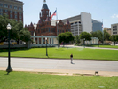 A woman poses for a photograph stood on the X that marks the approximate spot of the assasination of the 35th president of the United States, John F. Kennedy, in Dealey Plaza, Dallas.Dallas is a major city in Texas and is the largest urban center of the fourth most populous metropolitan area in the United States. The city ranks ninth in the U.S. and third in Texas after Houston and San Antonio. The city's prominence arose from its historical importance as a center for the oil and cotton industries, and its position along numerous railroad lines.For two weeks in the summer of 2015, photographer Peter Dench visited Dallas to document the metroplex in his epic reportage, DENCH DOES DALLAS.Photographed using an Olympus E-M5 Mark II©Peter Dench/Getty Images Reportage