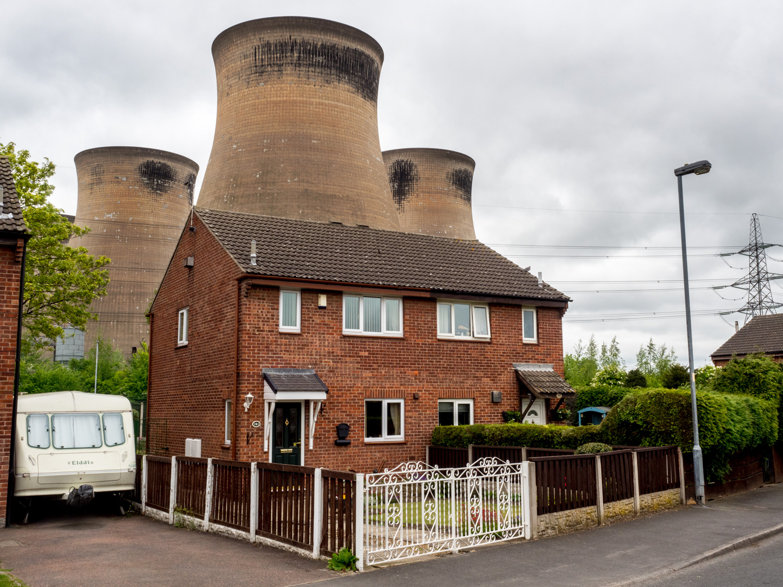 Houses situated in close proximity to the cooling towers at Ferrybridge Power Station. Knottingley, West Yorkshire.