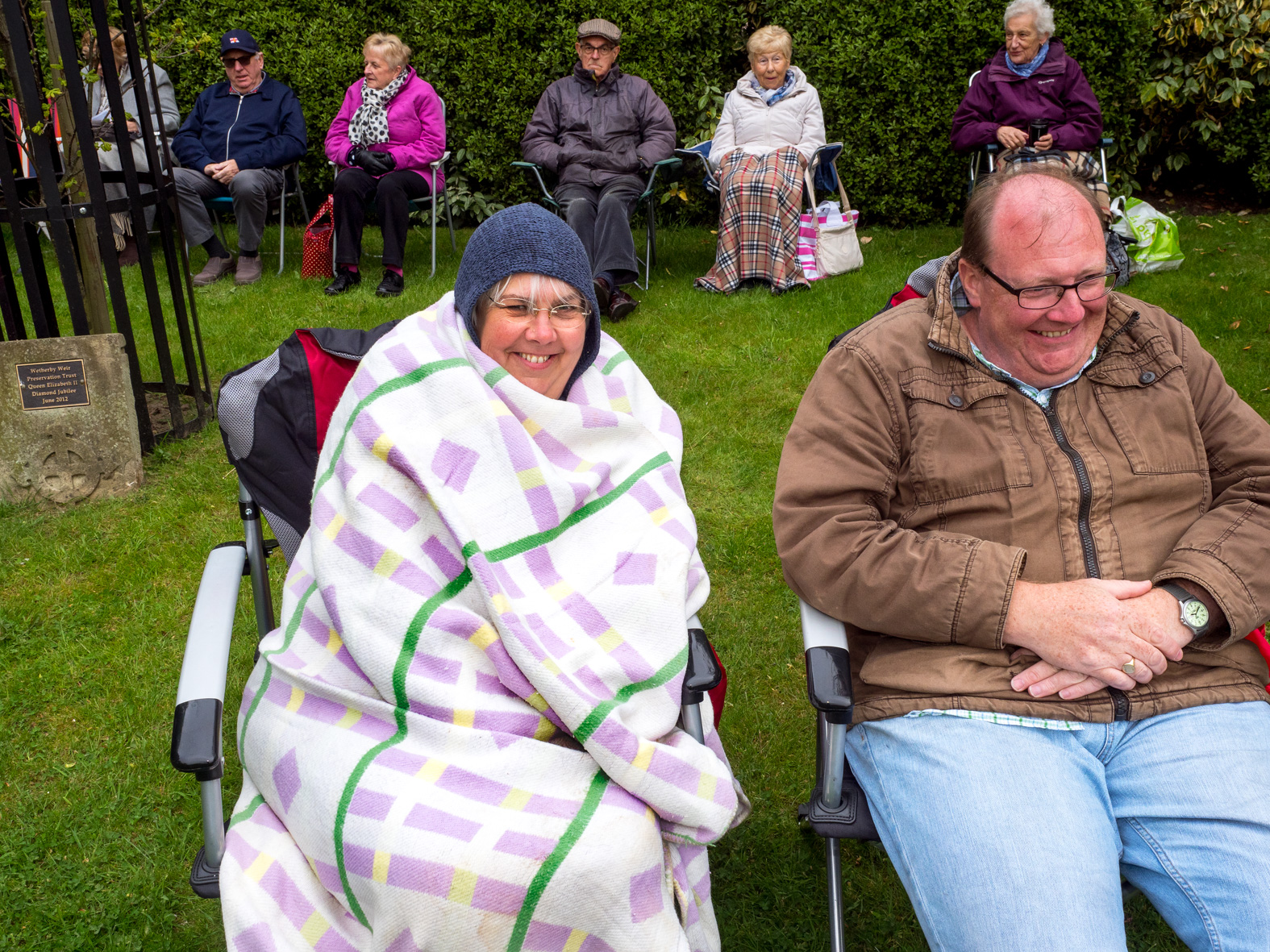 Members of the public wrap up warm while listening to an outdooe music performance. Wetherby, West Yorkshire.