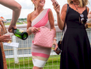 A woman with a Chanel bag socialises with friends at Epsom.Ladies' Day is traditionally held on the first Friday of June, a multitude of ladies and gents head to Epsom Downs Racecourse to experience a day full of high octane racing, music, glamour and fashion.