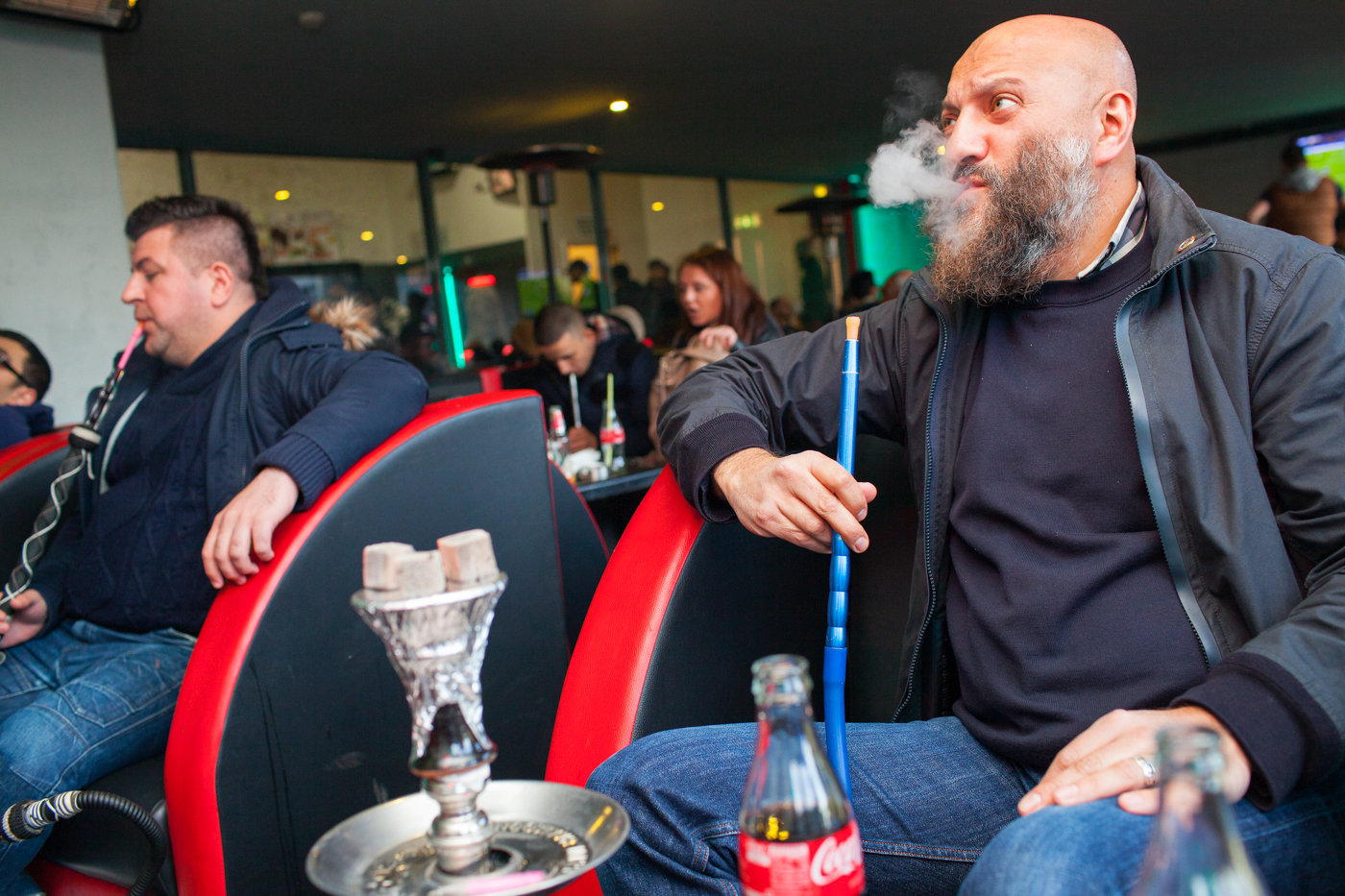 LEICESTER, UK MAY 2016RIAZ KHAN, a 50-year-old former football hooligan turned teacher watches Chelsea v Tottenham Hotspur on TV in a Shisha lounge in his home town of Leicester.On the 2nd May 2016, Leicester City football club became champions of England for the first time in their 132 year history.Leicester has been dubbed as most multicultural diversified city in England, thanks to scores of people that have flocked the city and who have hailed from different parts of the world. According to the Leicester city council, the city has the highest number of immigrants who have sought both temporary and permanent residence in England. Majority of these immigrants are people who have left their home countries in pursuit of job opportunities in England.  Photo by Peter Dench/Getty Images Assignment for ESPN