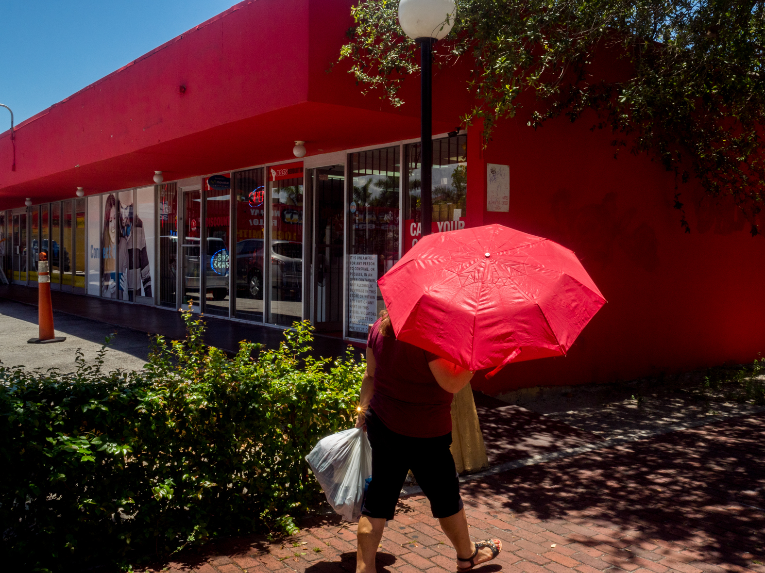 A woman with a red parasol walking through the Little Havana district of Miami.Miami is a seaport city on the Atlantic Ocean in south Florida. Miami's metro area is the eighth-most populous and fourth-largest urban area in the U.S., with a population of around 5.5 million.Miami is a major center, and a leader in finance, commerce, culture, media, entertainment, the arts, and international trade. In 2008, Forbes magazine ranked Miami {quote}America's Cleanest City{quote}, for its year-round good air quality, vast green spaces, clean drinking water, clean streets, and city-wide recycling programs. According to a 2009 UBS study of 73 world cities, Miami was ranked as the richest city in the United States, and the world's fifth-richest city in terms of purchasing power. Miami is nicknamed the {quote}Capital of Latin America{quote}, is the second largest U.S. city with a Spanish-speaking majority, and the largest city with a Cuban-American plurality.©Peter Dench/Getty Images Reportage