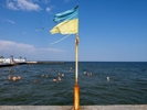 ODESSA, UKRAINE - AUGUST 26:  Visitors to the  beach on August 26, 2023 in Odessa, Ukraine. Several beaches in Ukraine's Black Sea city port of Odessa were officially reopened for swimming for the first time since the start of the Russian invasion, bathing remained banned during air raid alerts, an Anti-mine net was placed in between two piers to prevent swimmers encountering shallow-water mines many of which were dislodged by flood waters from the destruction of Kakhovka dam under control of the Russian military. The opening of the beaches has been a welcome respite from the tensions of war. (Photo by Peter Dench/Getty Images)