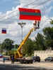 TIRASPOL, TRANSNISTRIA / MOLDOVA - SEPTEMBER 1: Red, white and blue Russian flags fly alongside the red and green of PMR, the only state in the world that uses the hammer and sickle on its flag as it is hoisted ahead of Republic Day on September 1, 2023 in Tiraspol, Moldova (Pridnestrovian Moldavian Republic). Tiraspol is the capital of Transnistria situated on the eastern bank of the Dniester River. Republic Day is the main state holiday. Transnistria broke away from Moldova in 1990 and is unrecognised by the international community as an independent state. The de-facto administration of Transnistria is supported economically, diplomatically, and militarily by Russia, which is believed to have 1,500 soldiers stationed there. (Photo by Peter Dench/Getty Images)