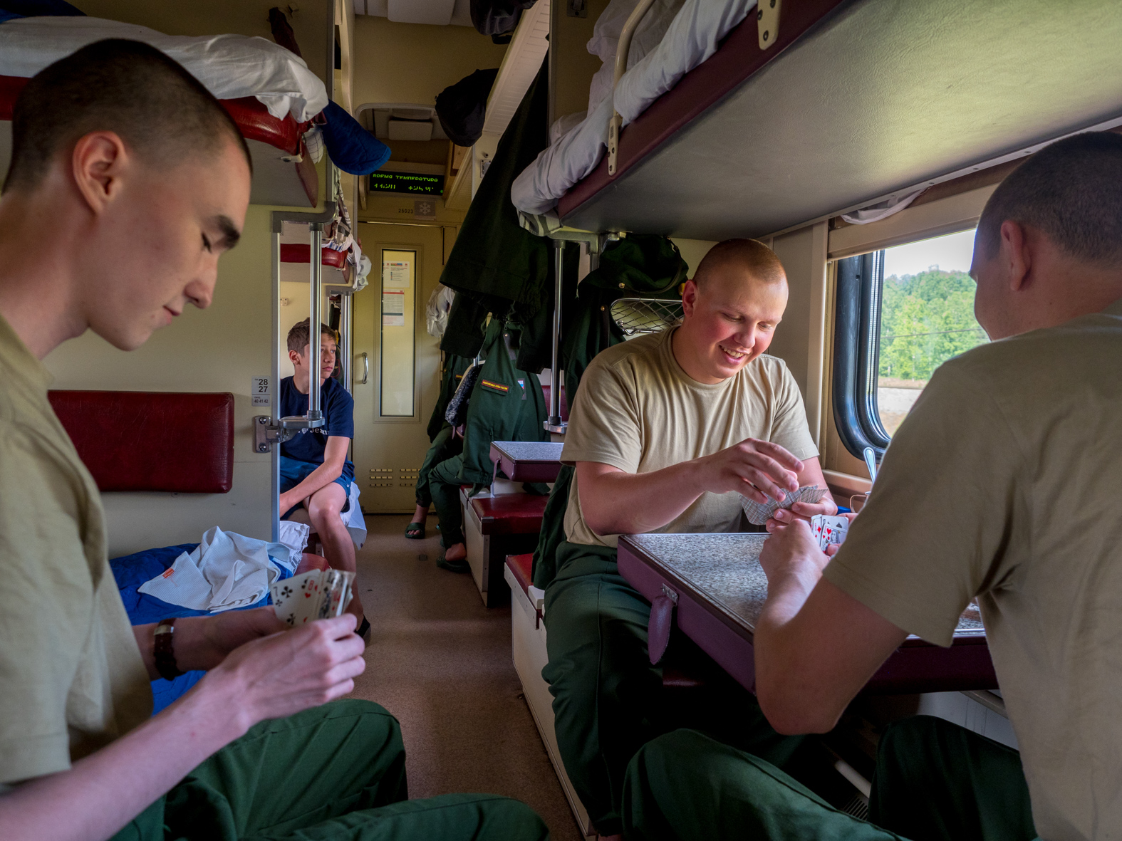 Army recruits play cards in a third class carriage on the Trans-Siberian Railway from Moscow-Vladivostok. Spanning a length of 9,289km, it's the longest uninterrupted single country train journey in the world. It has connected Moscow with Vladivostok since 1916, and is still being expanded. It was built between 1891 and 1916 under the supervision of Russian government ministers personally appointed by Tsar Alexander III and his son, the Tsarevich Nicholas (later Tsar Nicholas II).