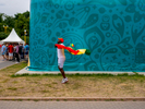 A Senegal football fan arrives at the Moscow FIFA Fan Fest located at Vorobyovy Gory (Sparrow Hills) with a venue Capacity of 25,000. The site provides a spectacular view down the hill, directly towards Luzhniki Stadium and Moscow City. The 21st FIFA World Cup football tournament took place in Russia in 2018. It was the first World Cup to be held in Eastern Europe and the eleventh time that it has been held in Europe. For the first time the tournament took place on two continents – Europe and Asia. All but two of the stadium venues were in European Russia.